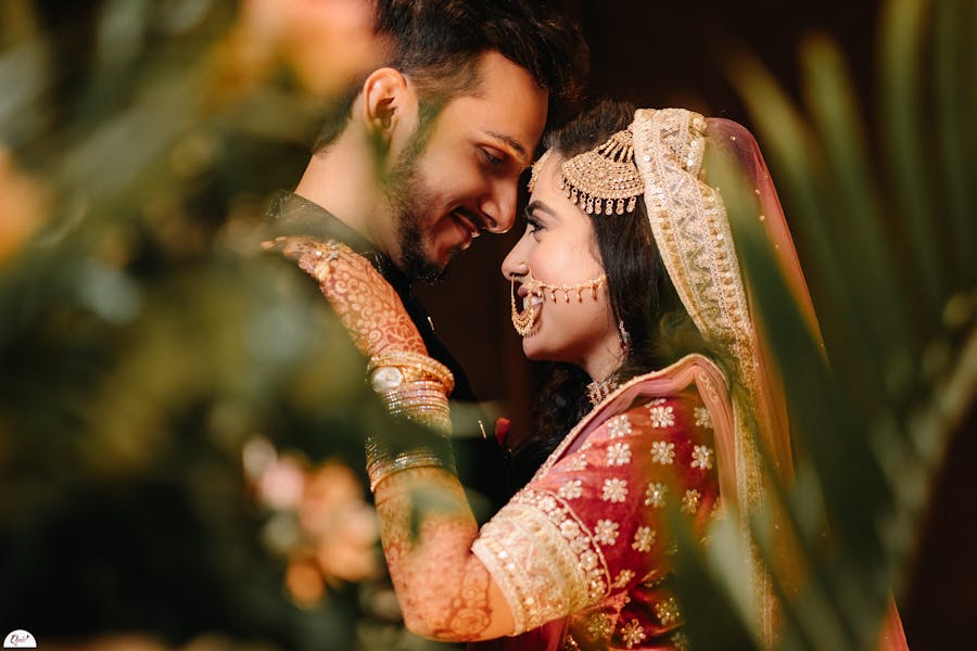 A close up forehead touch pose with bride and groom
