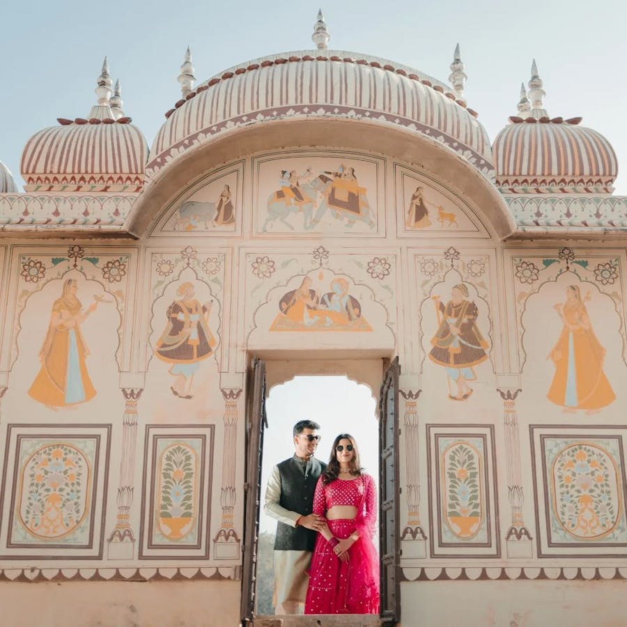 Couple pose in a dome shaped gate