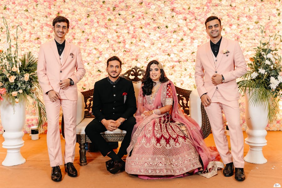 Couple posing with brothers in wedding