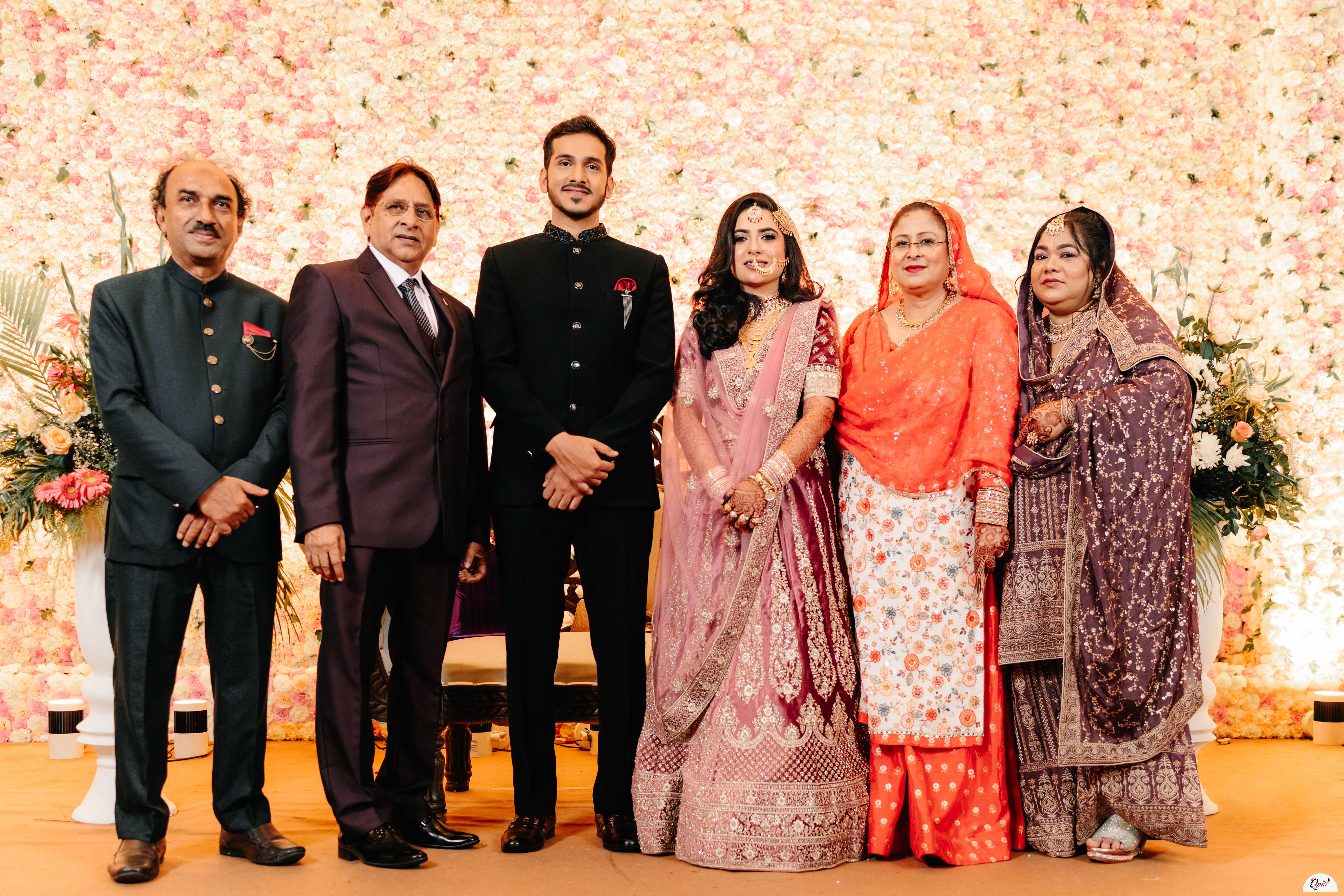 Group photo of couple with family in their wedding