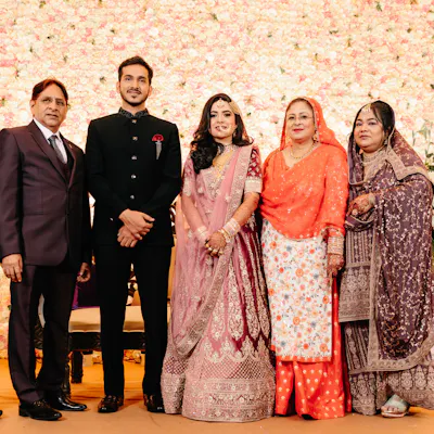 Group photo of couple with family in their wedding