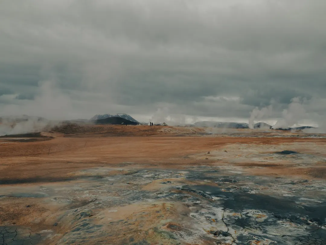 steam rises from the ground in a barren area