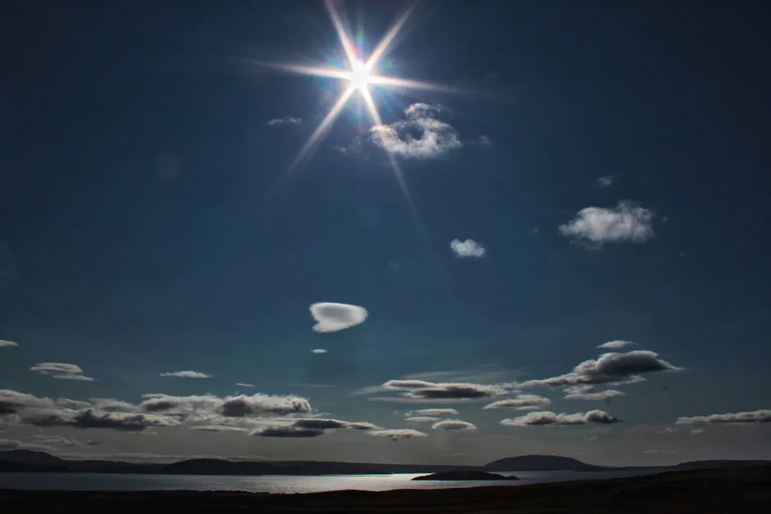 the sun shining through clouds