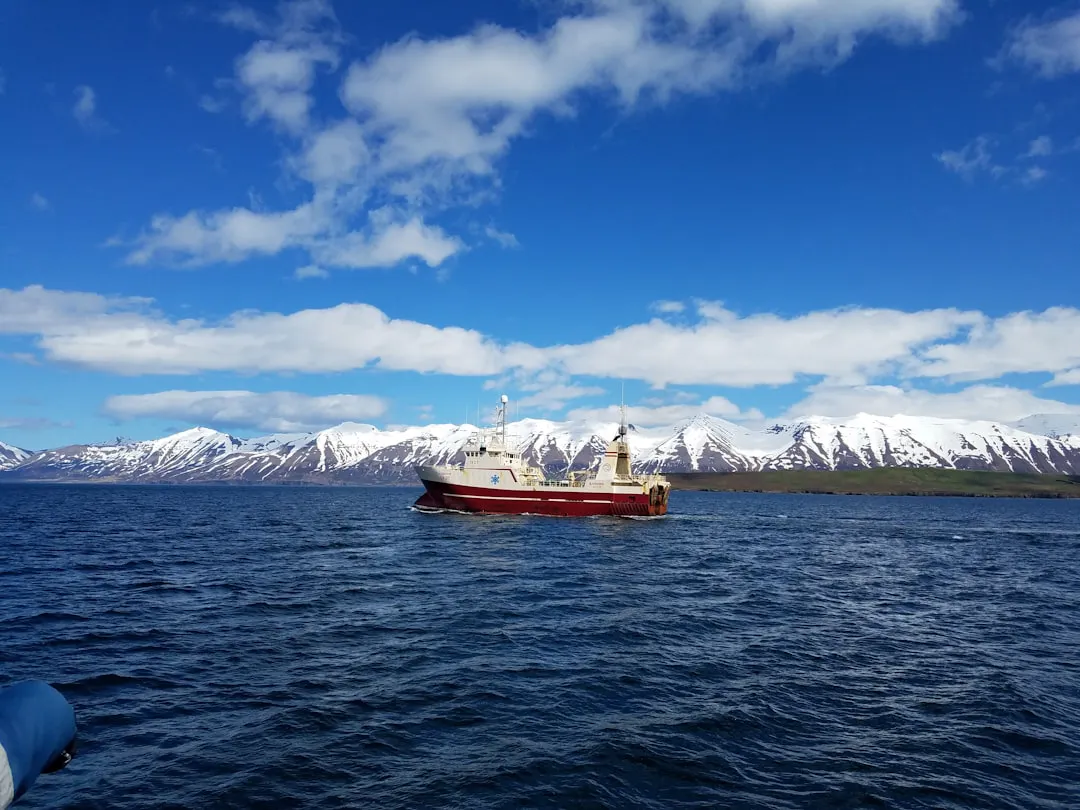 A boat floating on top of a large body of water