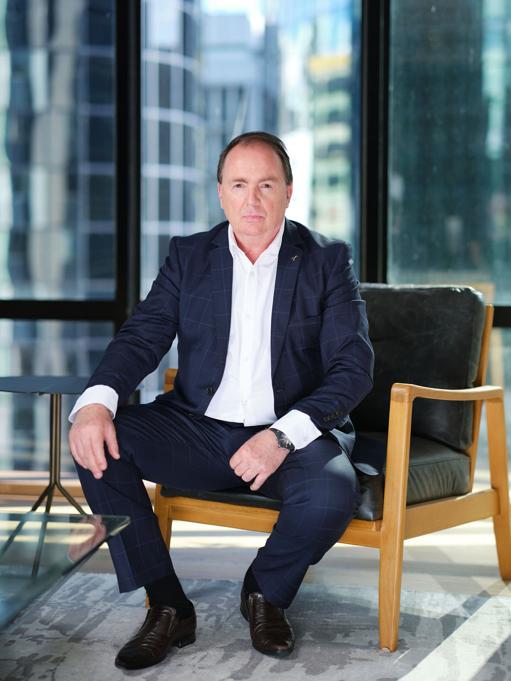 male lawyer posing for photo with city background