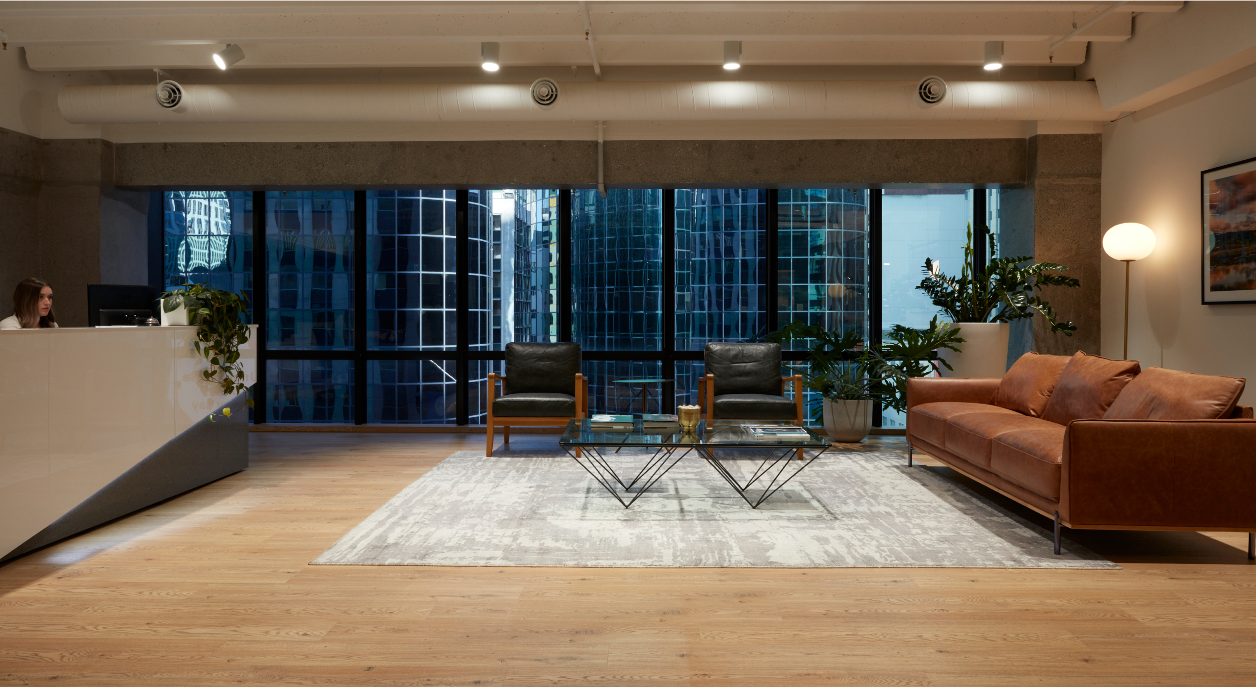 Law firm reception area with couches and view of the city