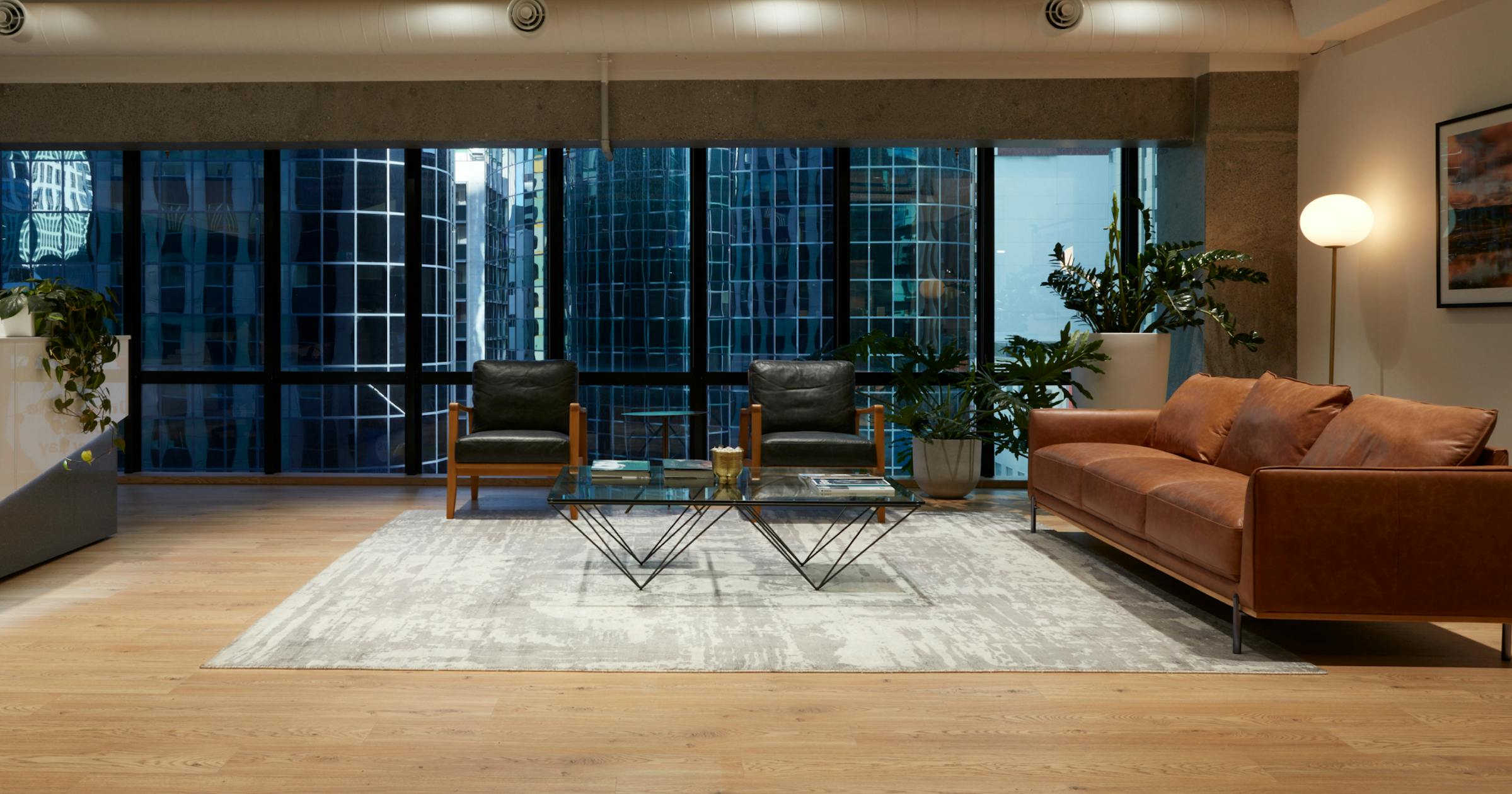Law firm reception area with couches and view of the city