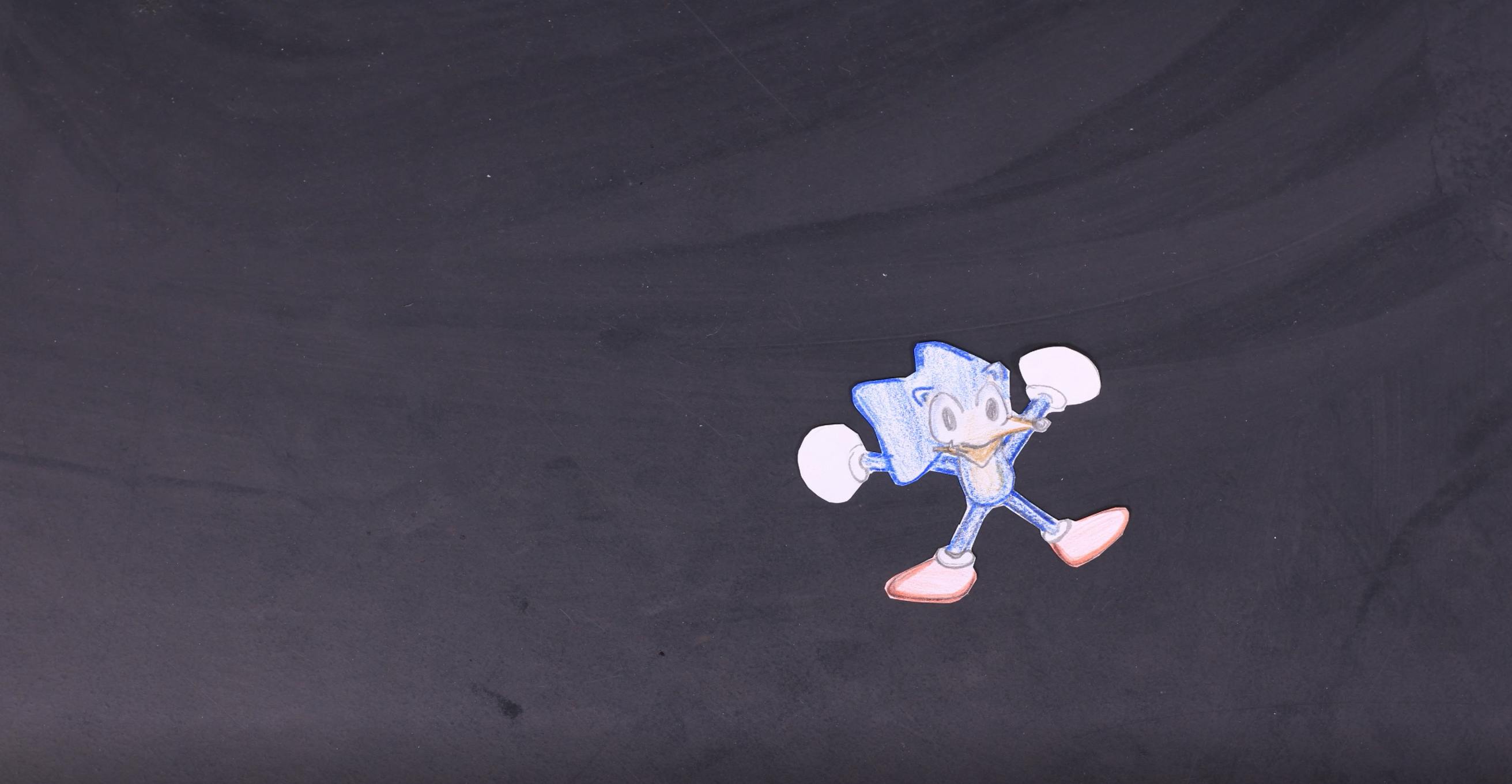 Image of Sonic the Hedgehog made out of paper with his limbs extended