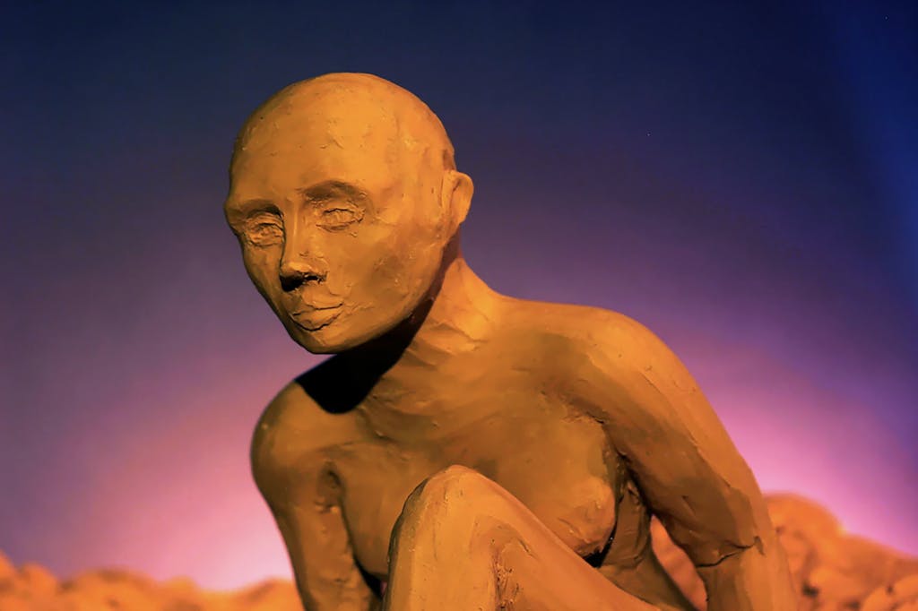 Still from Evelyn Jane Ross' Adam, a clay figure sits in front of a purple background