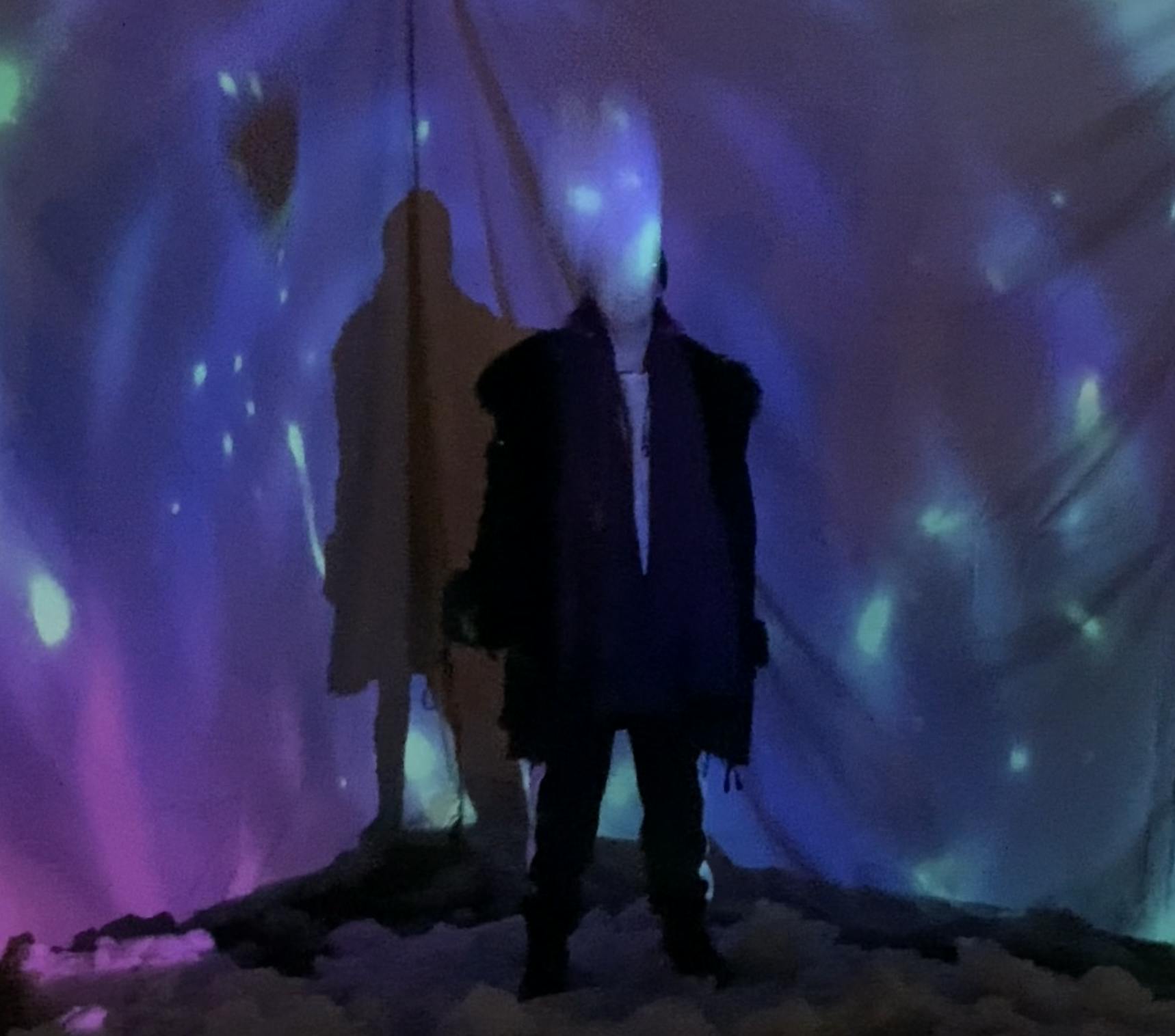 image of someone in front of an abstract projection map
