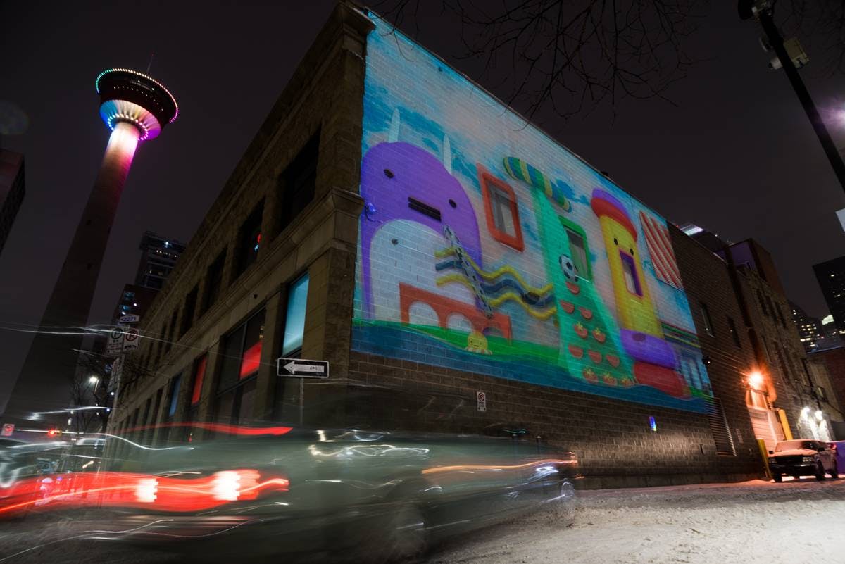 CGI characters projected onto a wall in downtown Calgary