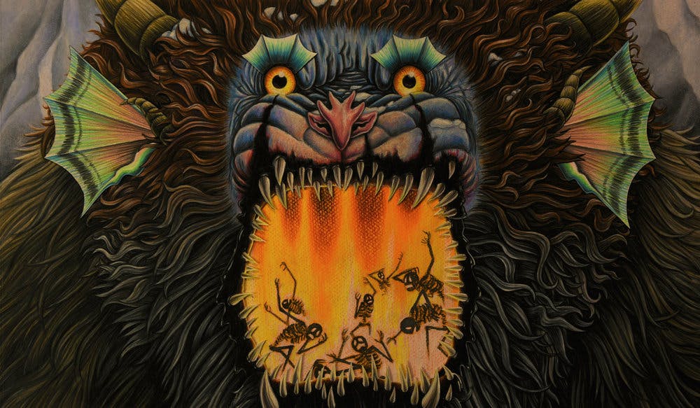 illustration of a large monster with fin ears, large fangs, and covered in fur with its mouth open. In the mouth there are 6 skeletons writhing in pain, engulfed in Flames