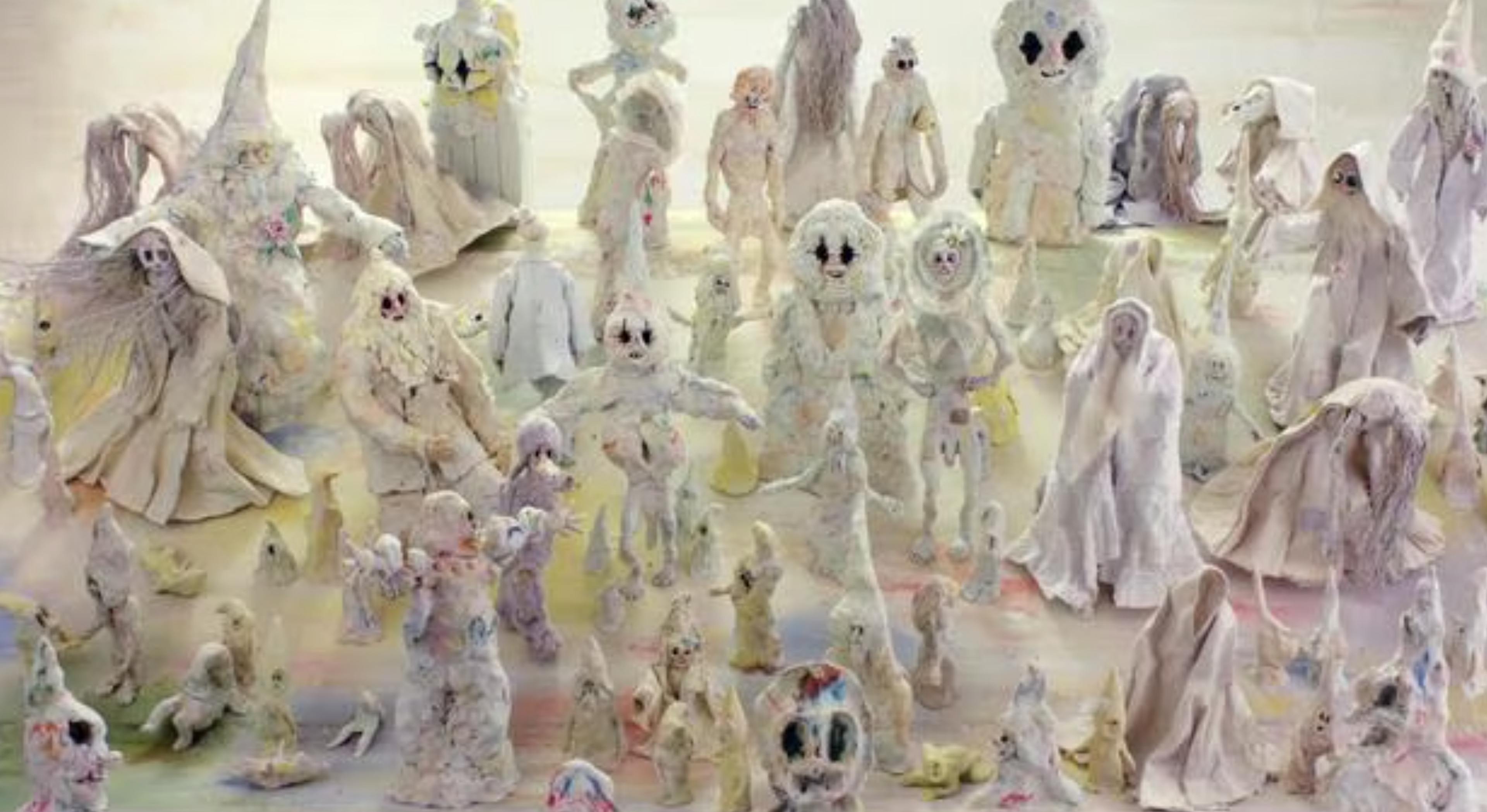 Image of a crowd of figures out of clay, with big eyes and cloaks looking at the camera. From Allison Schulnik's Mound (2011)