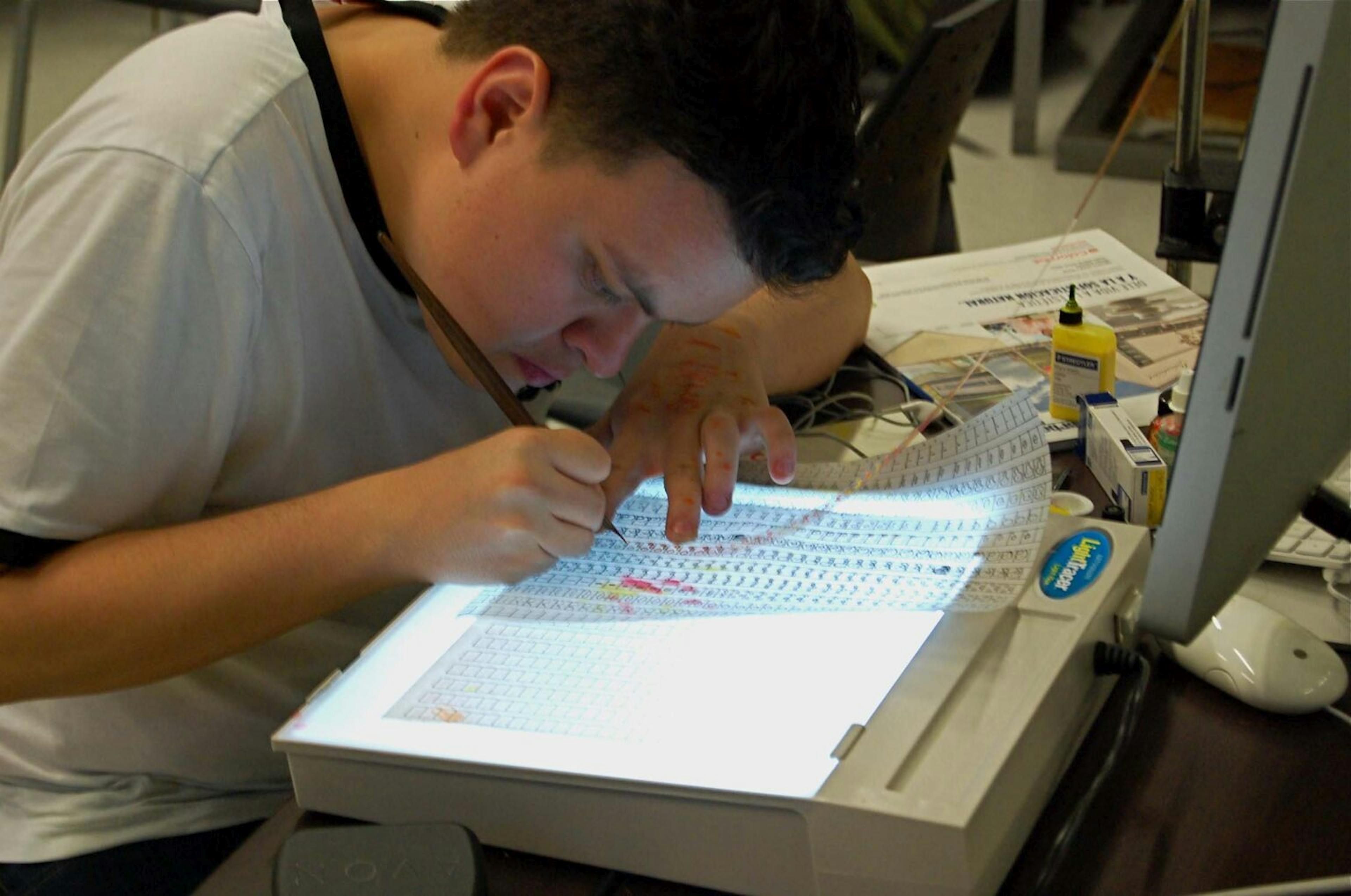  image of an individual working on cameraless animation from a workshop richard reeves did in Colombia.