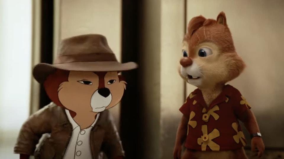 Still from the Chip 'n Dale Rescue Rangers trailer: a 2D-styled Dale, wearing photorealistic clothing, glares at something off-camera as a CGI Chip (a chipmunk in a Hawaiian shirt) looks on