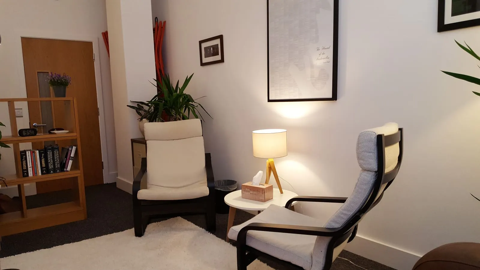 The Quiet Room therapy room in St Helier: two armchairs, a lamp and plants