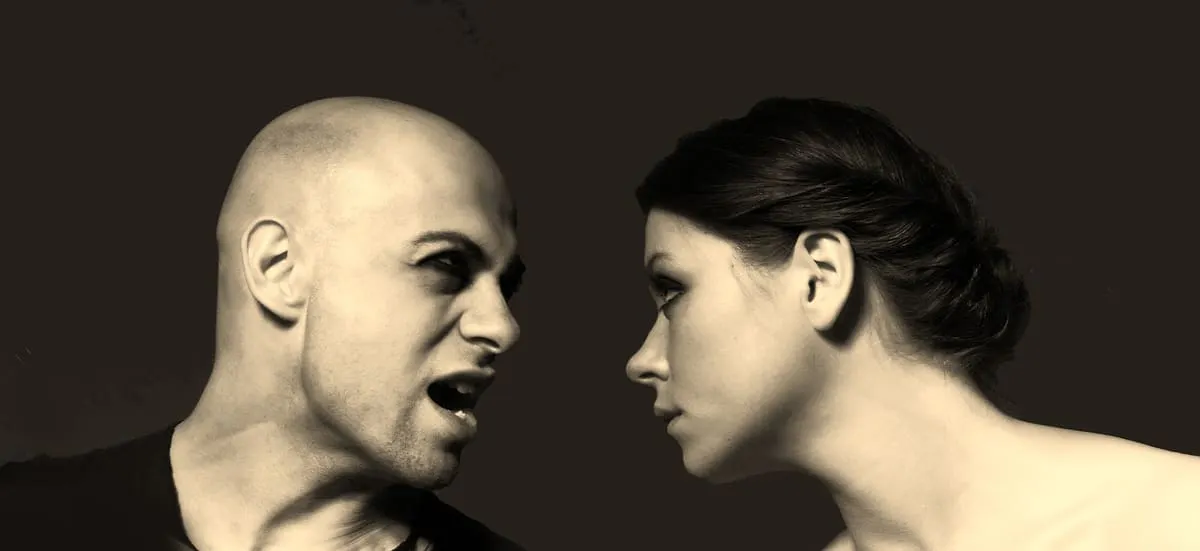 A couple facing each other in a tense conversation