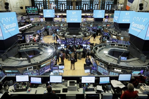 a room full of people, screens and computer screens, stock market