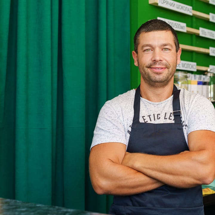 Man smiling wearing an apron