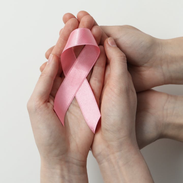 Hands holding a pink bow