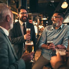 A group of colleagues drinking a beer at a pub