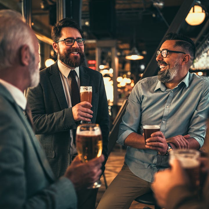A group of colleagues drinking a beer at a pub