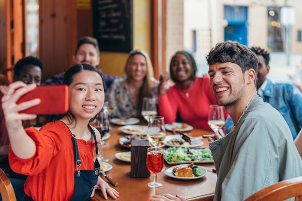 Employees gathered around a lunch table for a photo