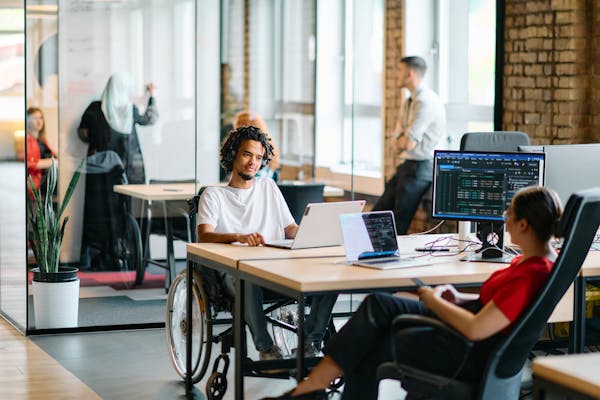 Office workers talking at a desk