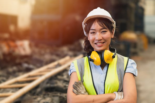 Woman in high vis jacket and hard hat