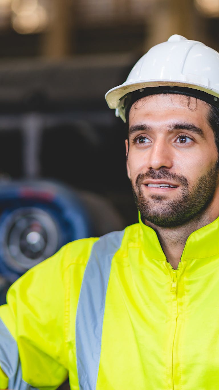 Man in hard hat and yellow high vis jacket