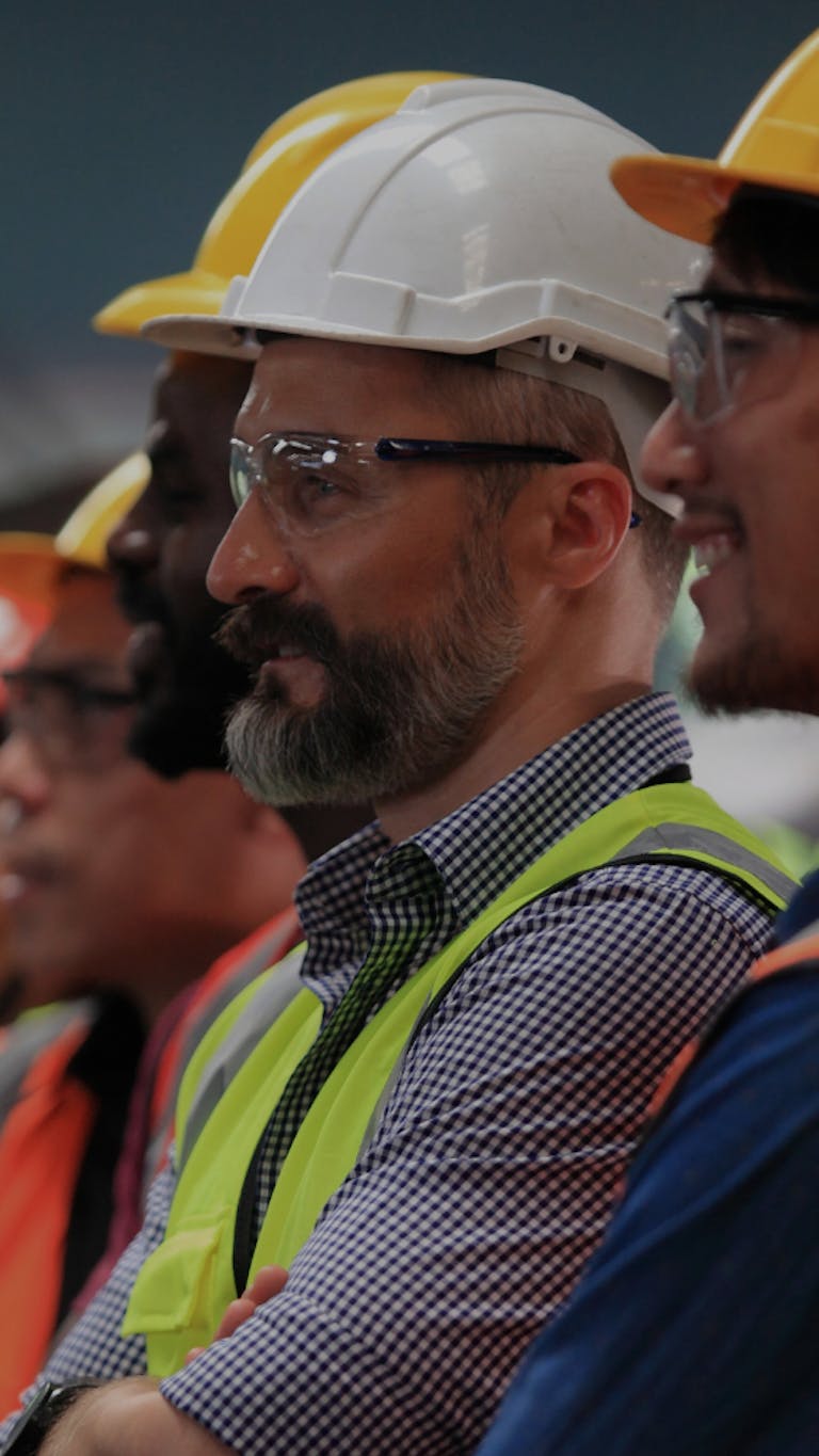 A team of workers in high vis and hard hats
