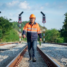 Train engineer inspecting tracks