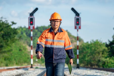 Train engineer inspecting tracks