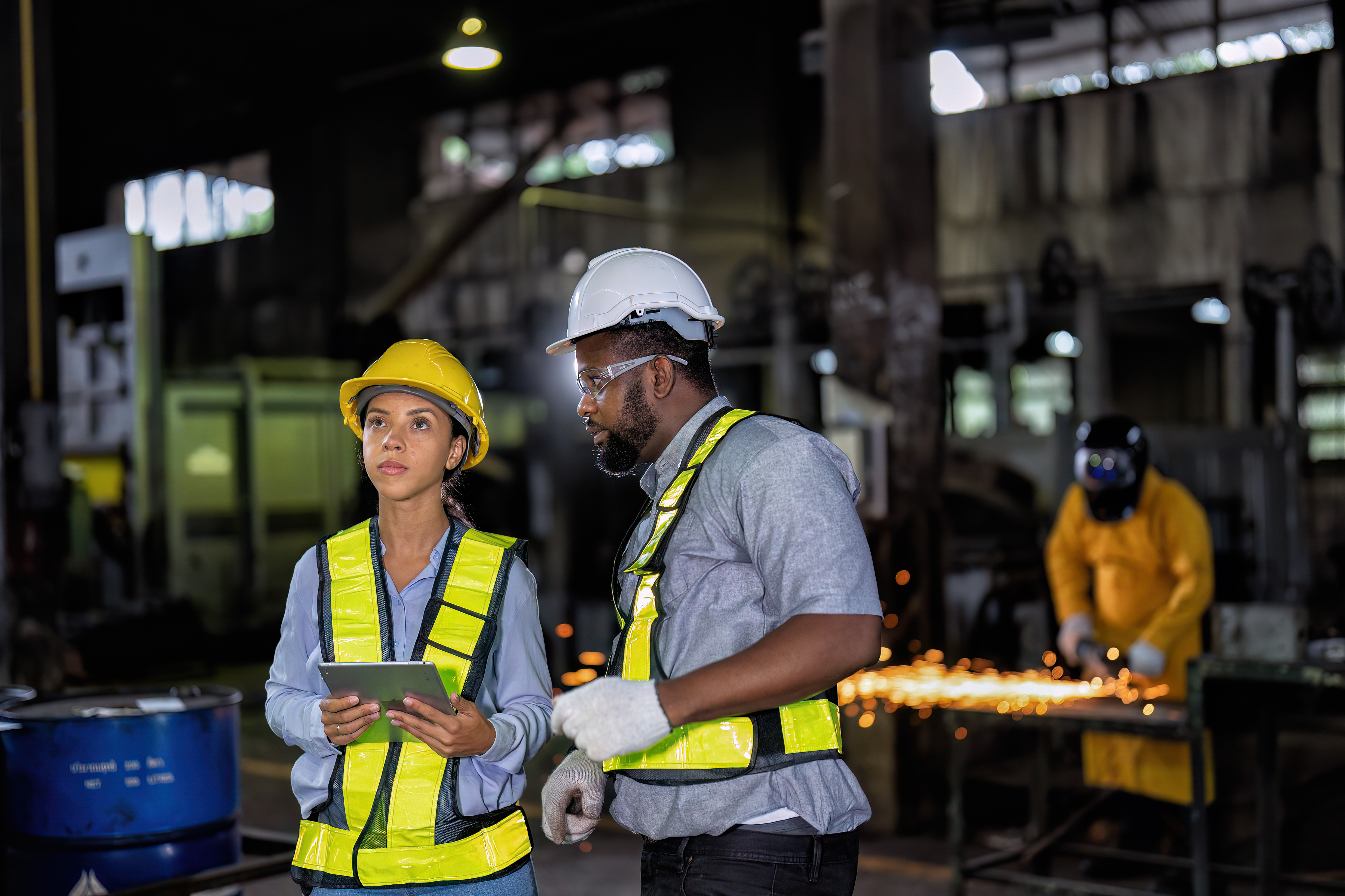 Two shift workers in manufacturing facility