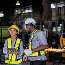 Two shift workers in manufacturing facility