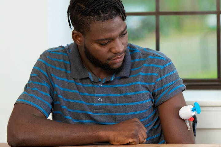 Man taking a blood sample with the TAPII device.jpg