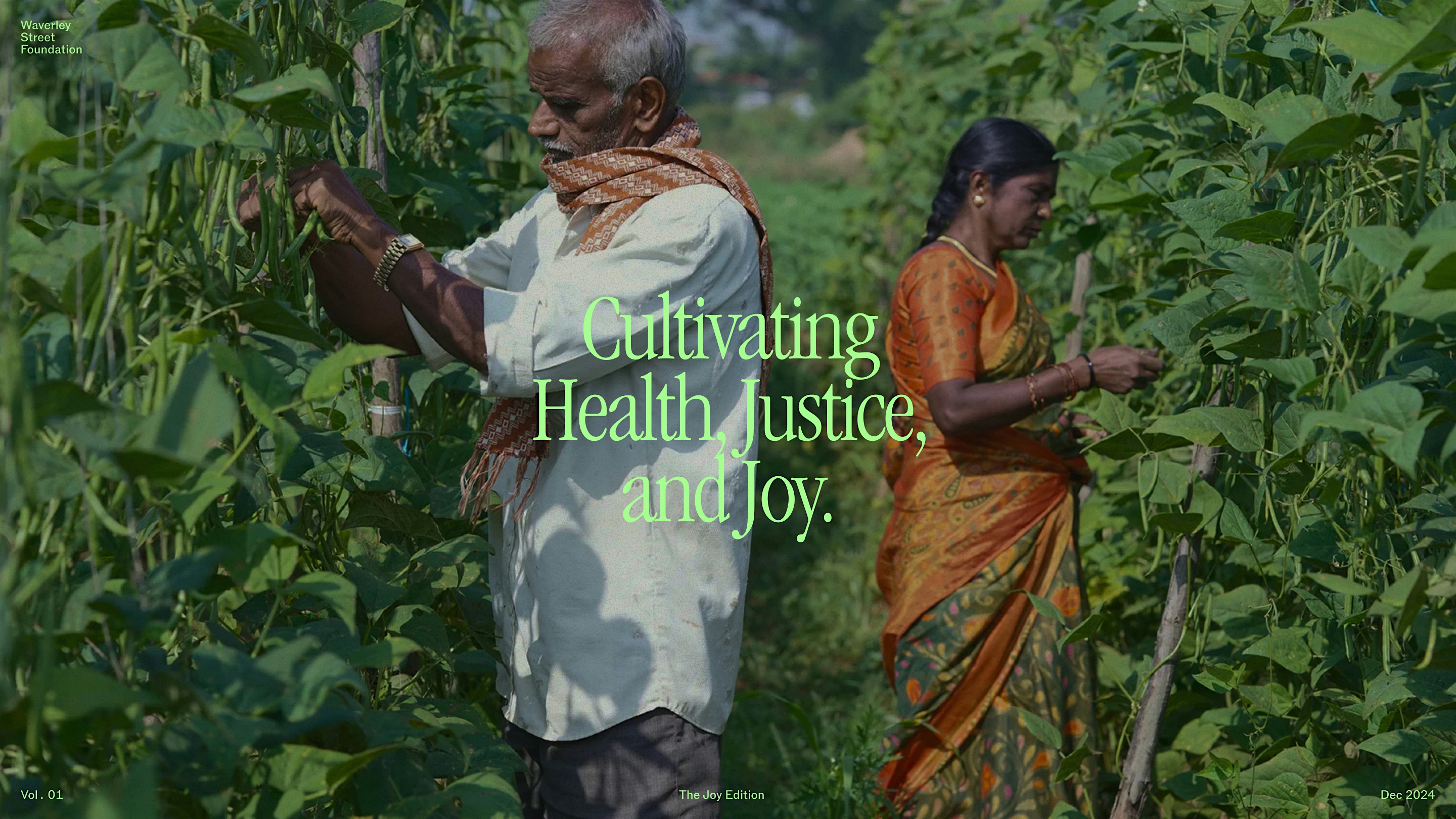A photograph showing two people working in a lush agricultural field with green plants. An older man in white clothing with an orange scarf and a woman in traditional orange attire tend to crops. Large white text overlay reads 'Cultivating Health, Justice, and Joy.' Small text at bottom indicates 'Vol. 01 The Joy Edition Dec 2024' with Waverley Street Foundation branding.