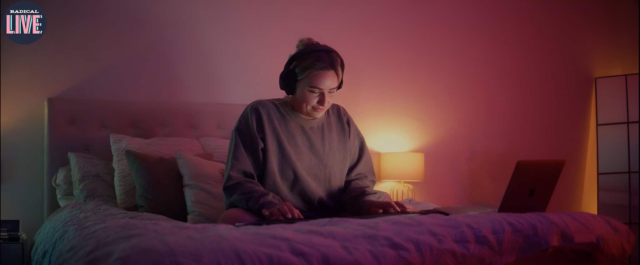 Girl playing piano on bed at home