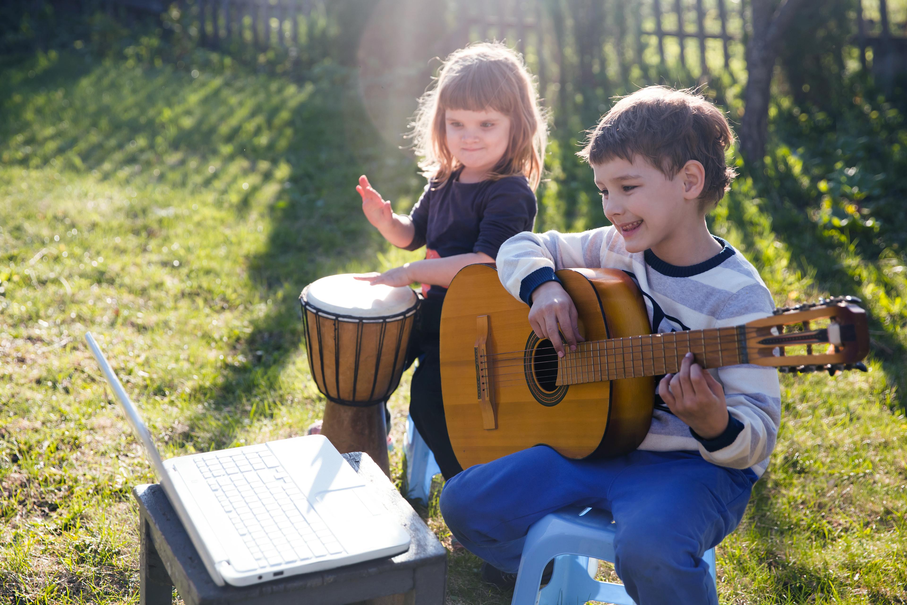 Boy and girl online music lesson summer