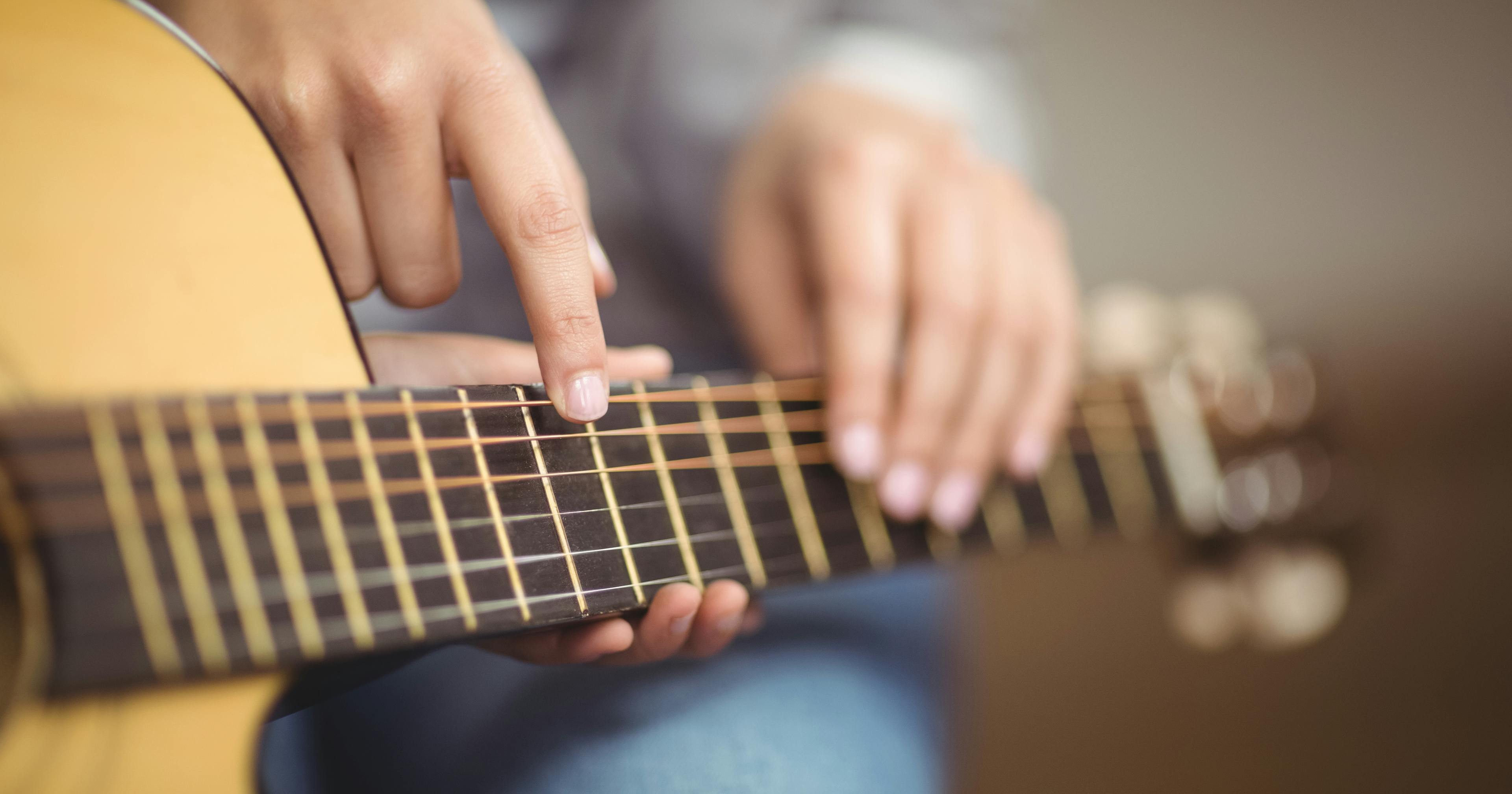 Child learning guitar online via live video lesson