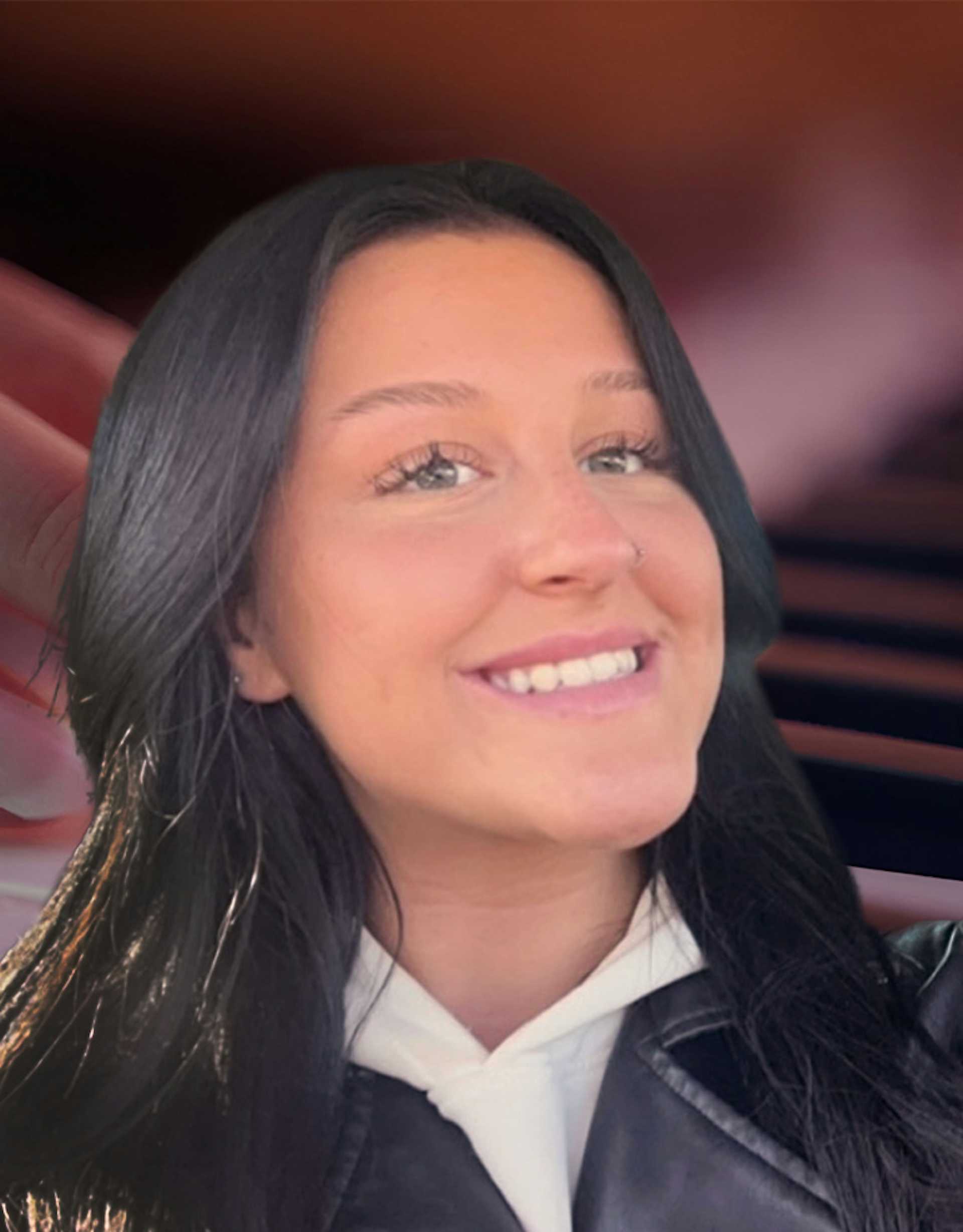 Piano teacher smiling with piano background