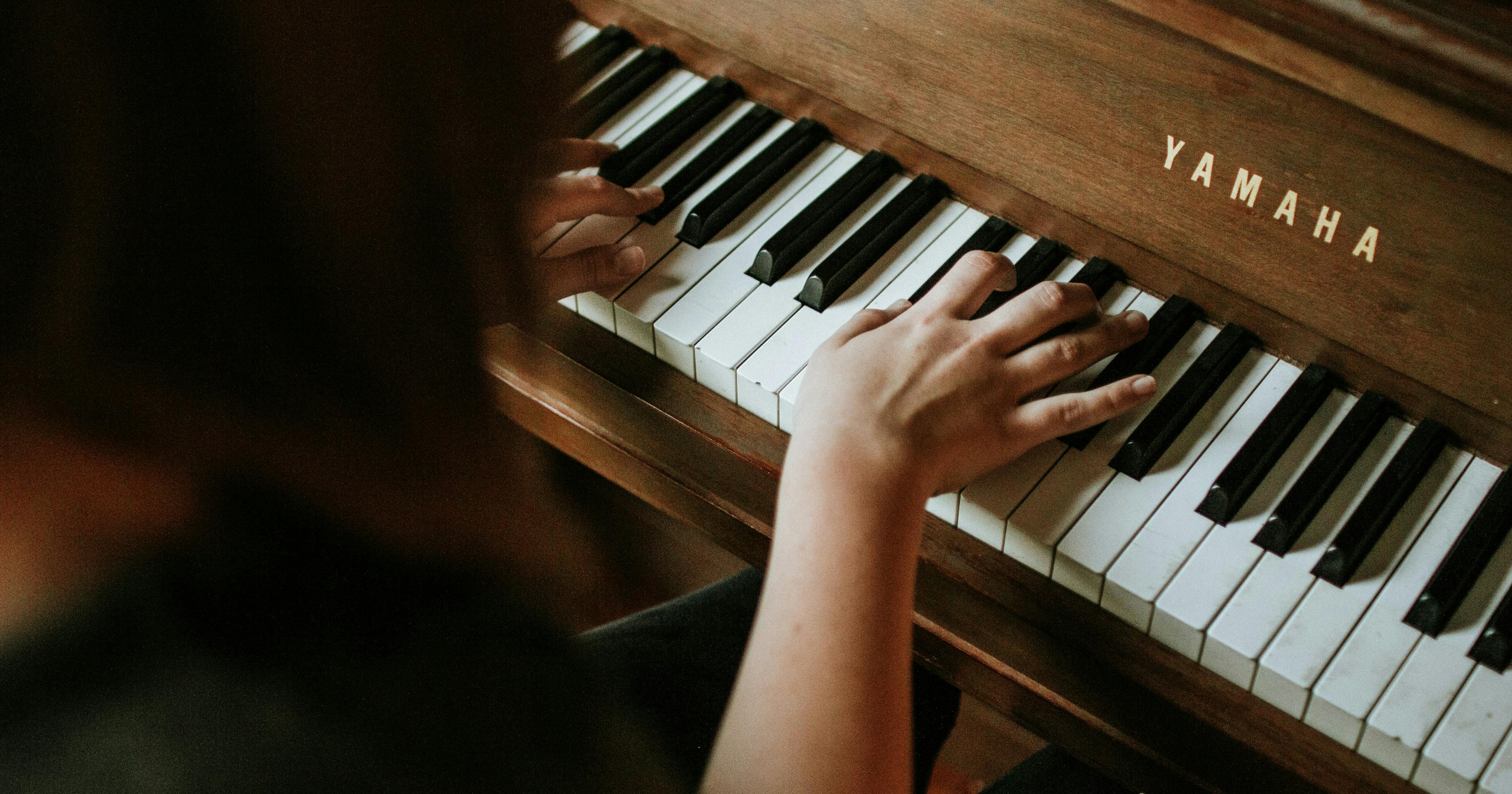 person playing and practicing piano