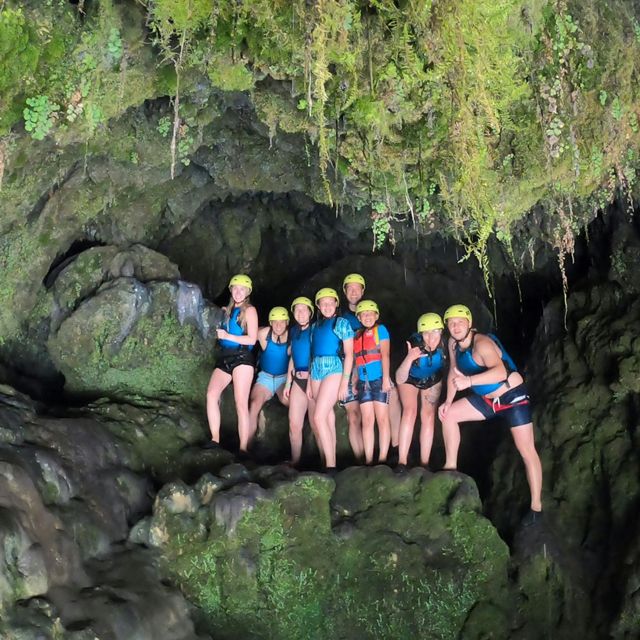 family taking a picture in front of the cave on cetina river rafting trip