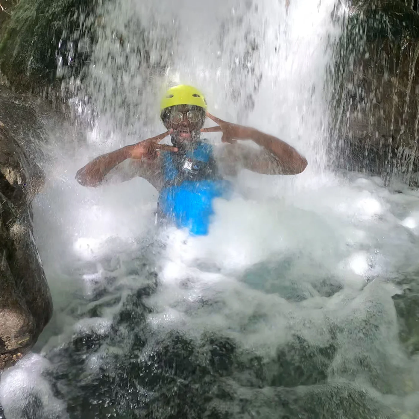 man having fun with under the waterfall on cetina river rafting trip
