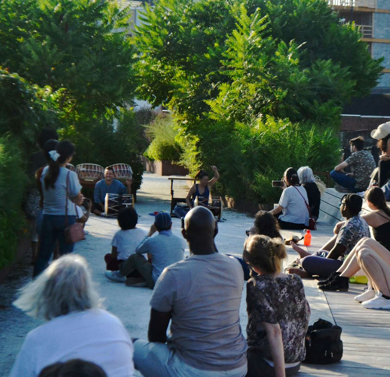 People watch a drum performance at the Rail Park