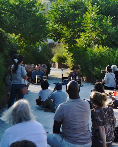 People watch a drum performance at the Rail Park