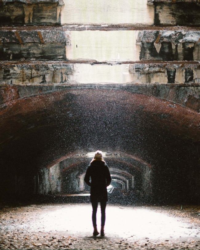 View of someone standing in the tunnel while snow falls