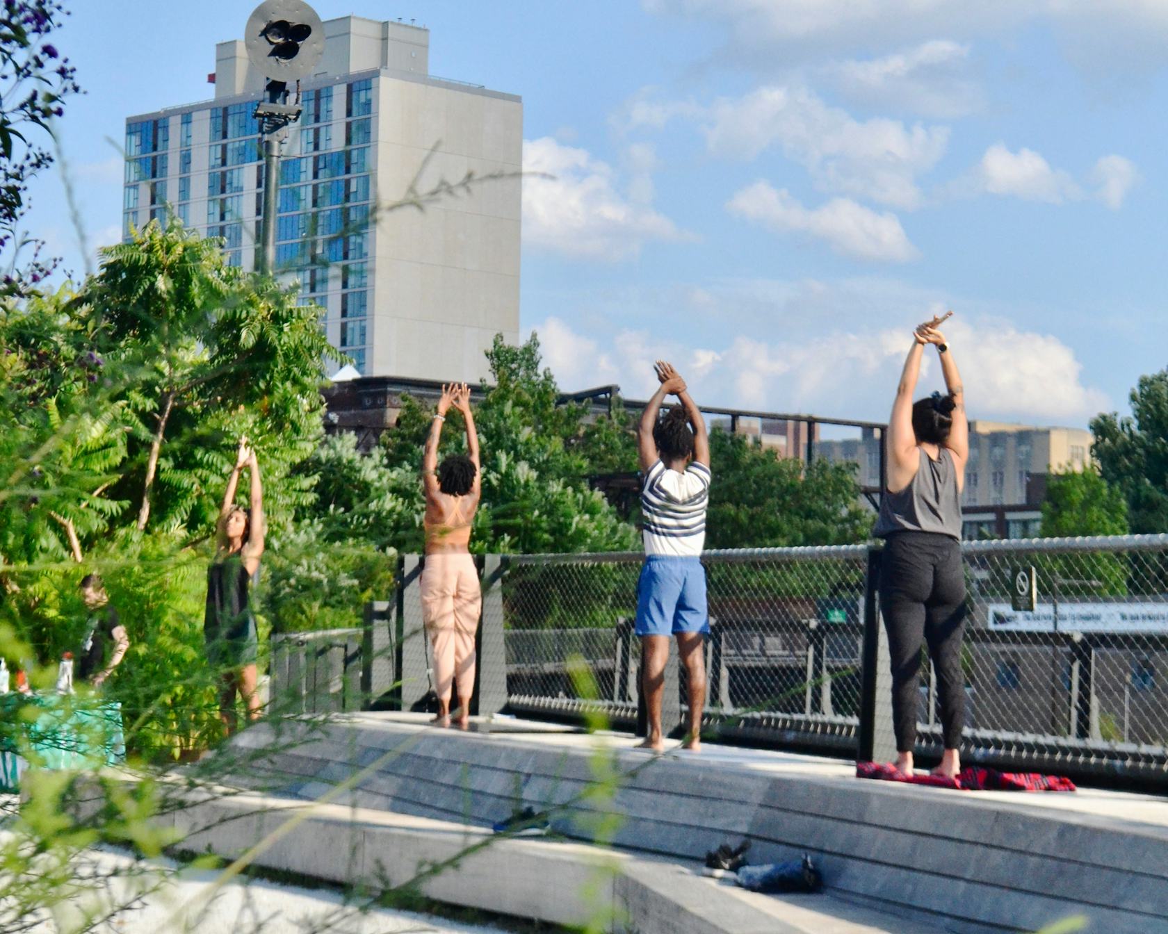 People do yoga at the Rail Park