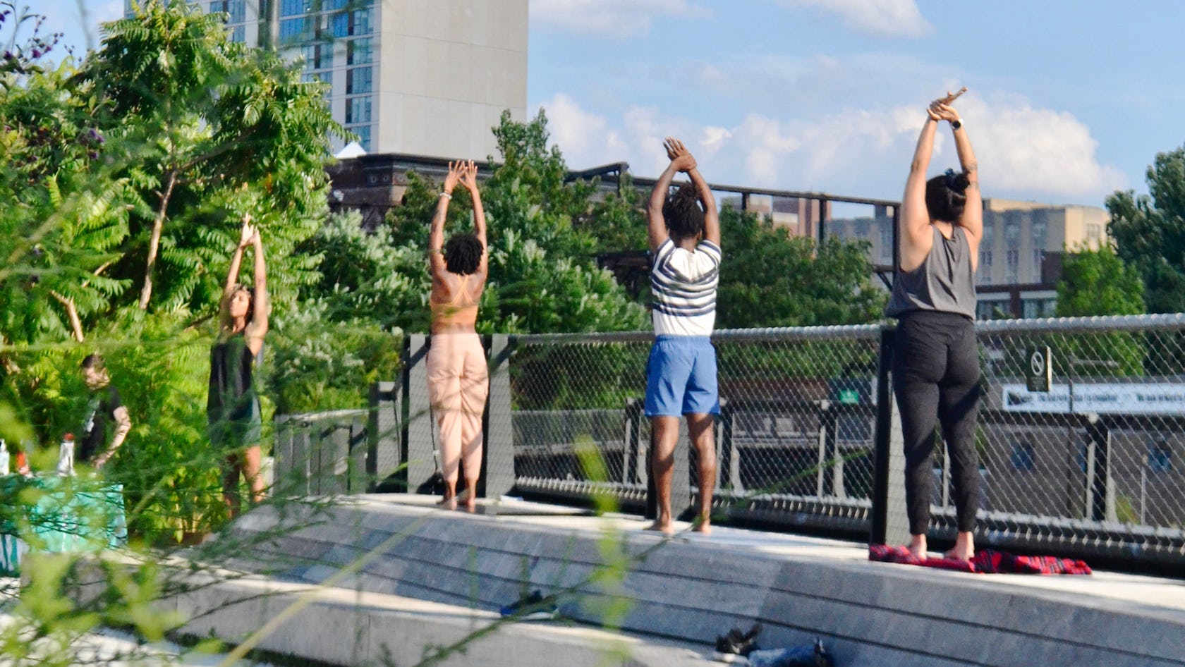 People do yoga at the Rail Park