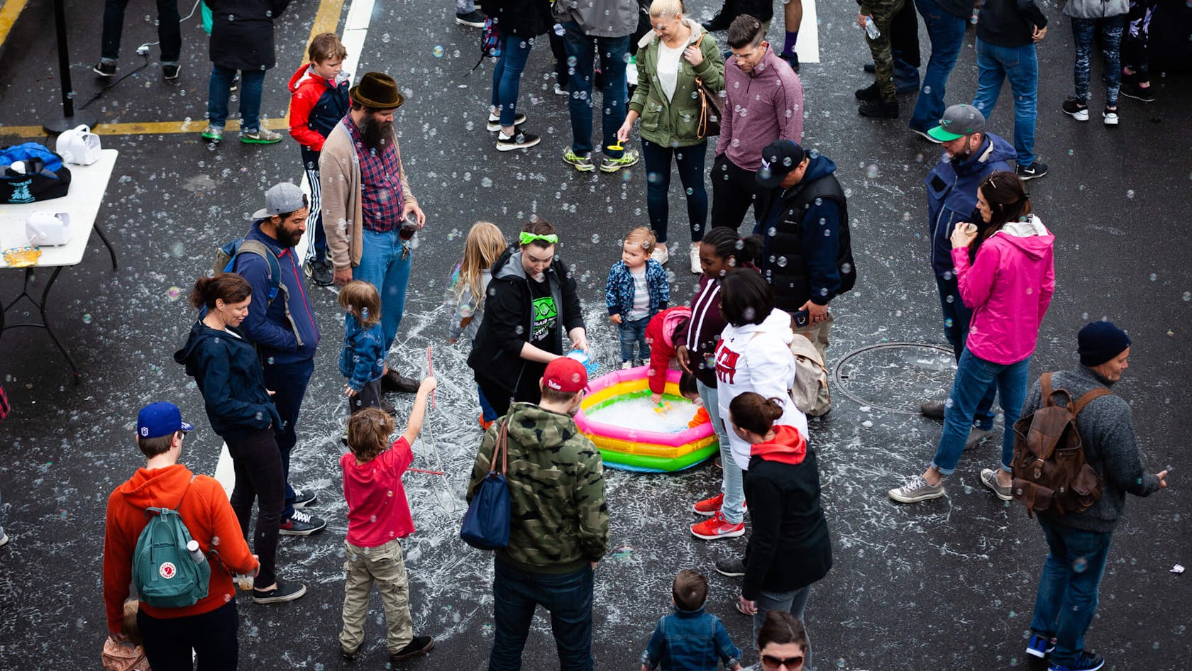 People play with bubbles on Callowhill Street below the Rail Park 